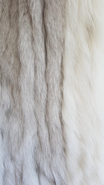 Fur detail on Saga Fox Pale blue fox fur jacket with long sleeves, a plush collar, and natural silver grey markings on a mannequin