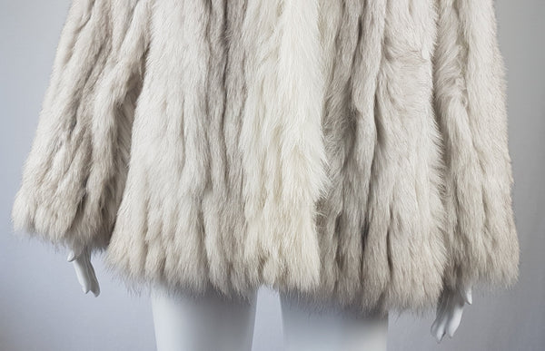 Saga Fox Pale blue fox fur jacket with long sleeves, a plush collar, and natural silver grey markings on a mannequin