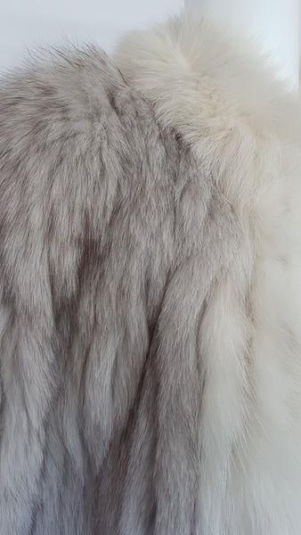 Collar and shoulder view of Saga Fox Pale blue fox fur jacket with long sleeves, a plush collar, and natural silver grey markings on a mannequin