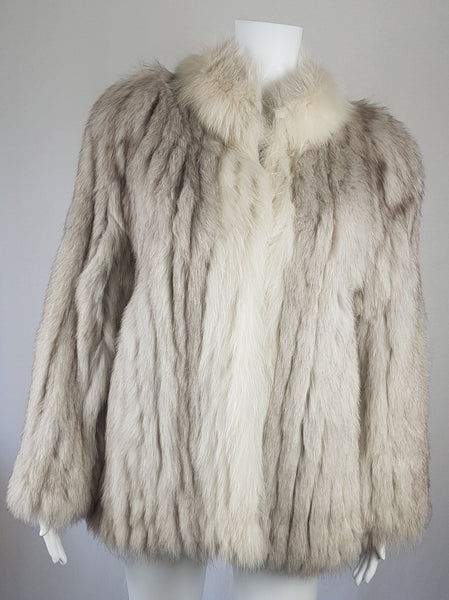 Saga Fox Pale blue fox fur jacket with long sleeves, a plush collar, and natural silver grey markings on a mannequin