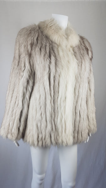 Saga Fox Pale blue fox fur jacket with long sleeves, a plush collar, and natural silver grey markings on a mannequin