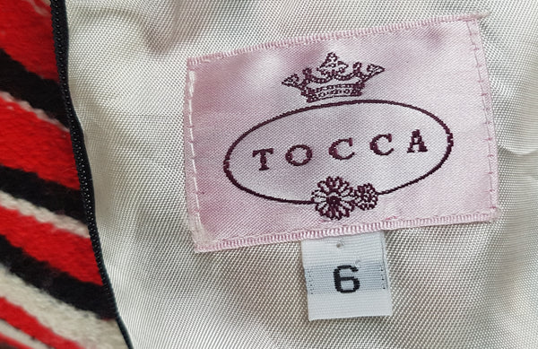 Close-up of the pink Tocca brand label and US size 6 label inside a modern Tocca woven dress