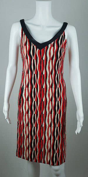 front view of a modern Tocca red, black and ivory Op Art woven sheath dress with black V-neck trim displayed on a mannequin