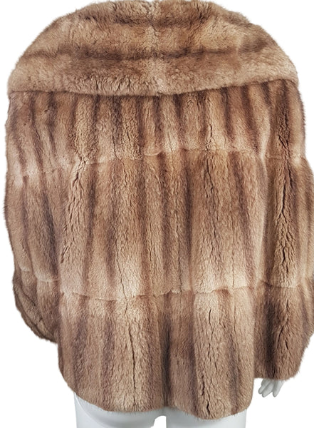 Full back view of a vintage 1950s Hudson’s Bay Company warm light-brown mink stole jacket with a shawl collar and three-quarter sleeves.
