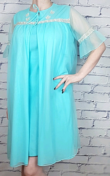 Vintage 1960's Azure Blue Sylvia Ann Peignoir Slip and Canadian Maid Gathered Yoke Robe Lingerie Set with silver and white decorative details on bust displayed on a woman - front view with robe closed