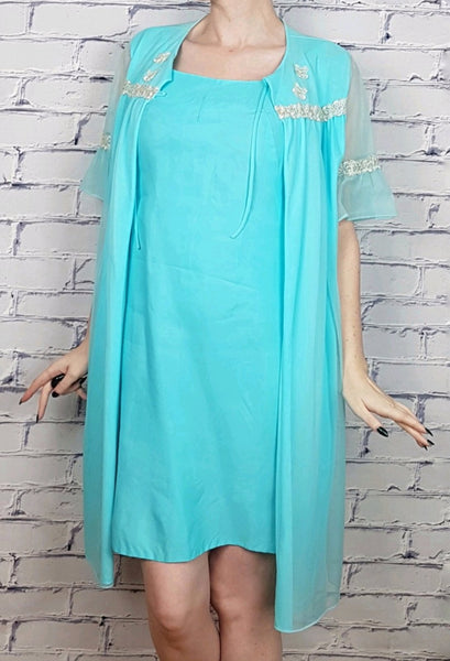Vintage 1960's Azure Blue Sylvia Ann Peignoir Slip and Canadian Maid Gathered Yoke Robe Lingerie Set with silver and white decorative details on bust displayed on a woman - front view with robe open