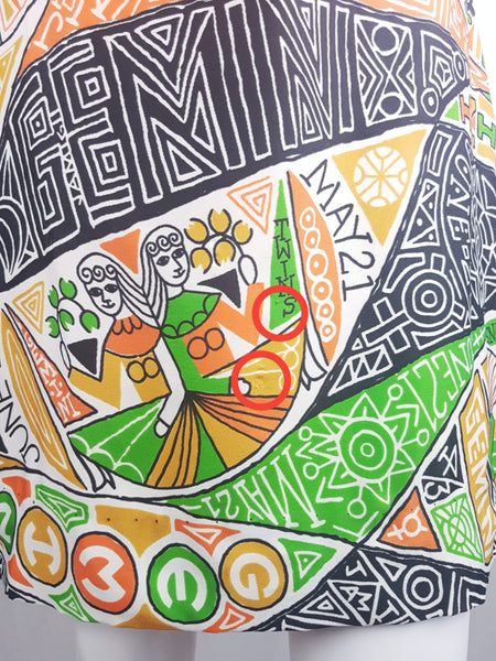 Minor flaws circled in red Close-up of the orange, green, mustard, black and white Gemini twins novelty print on a late 1960s zodiac dress.