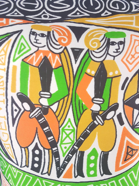 Close-up of the orange, green, mustard, black and white Gemini twins novelty print on a 1960s zodiac dress.