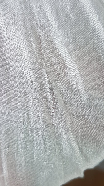 Close-up detail of fabric abrasions on 1960s Aristocraft nightgown - shown by hand under the sheer fabric