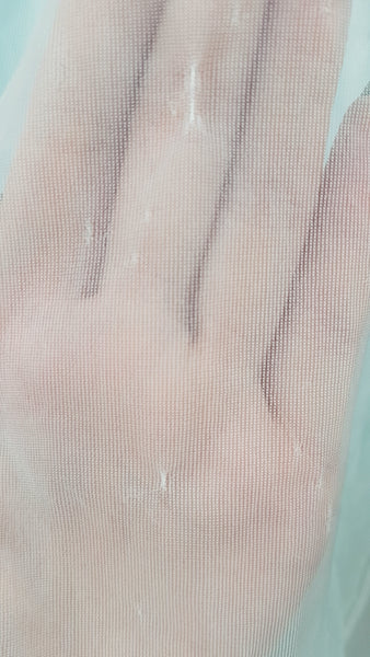 Close-up detail of minor fabric abrasions on the sheer pastel blue skirt of the 1960s Aristocraft nightgown - shown by hand under the sheer fabric