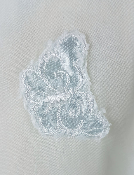 Applique closeup of Vintage 1960s Aristocraft by Superior pastel blue peignoir with cream floral lace and ribbon ties displayed on a mannequin