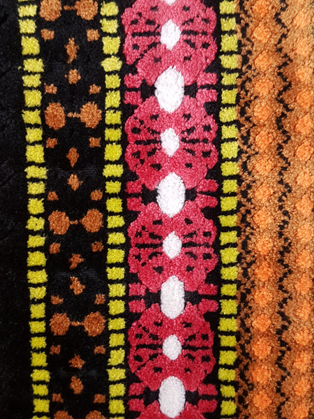 Close up view of black, pink, orange, and yellow geometric striped pattern on vintage 1960s Trego’s Westwear chenille coat