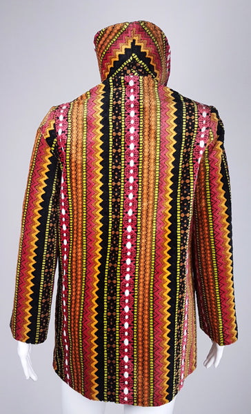 Full back view of a vintage 1960s Trego’s Westwear chenille coat with a raised funnel collar, colourful geometric stripes and angled pockets displayed on a mannequin 