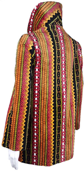 Full three quarter back view of a vintage 1960s Trego’s Westwear chenille coat with a raised funnel collar, colourful geometric stripes and angled pockets displayed on a mannequin 