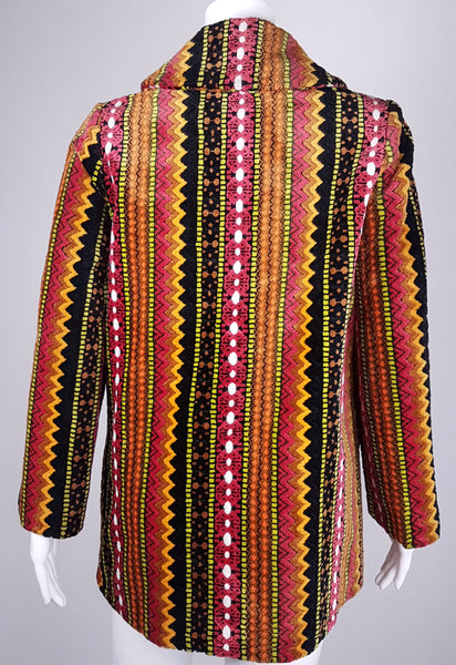 Full back view of a vintage 1960s Trego’s Westwear chenille coat with a folded collar, colourful geometric stripes and angled pockets displayed on a mannequin 