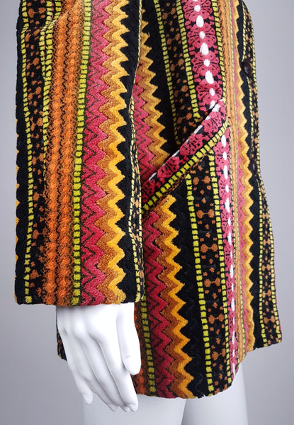 Side sleeve and pocket detail view of a vintage 1960s Trego’s Westwear chenille coat with colourful geometric stripes and angled pockets displayed on a mannequin 