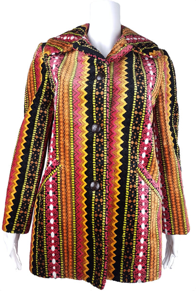 Full front view of a vintage 1960s Trego’s Westwear chenille coat with a fully buttoned funnel collar, colourful geometric stripes and angled pockets displayed on a mannequin 