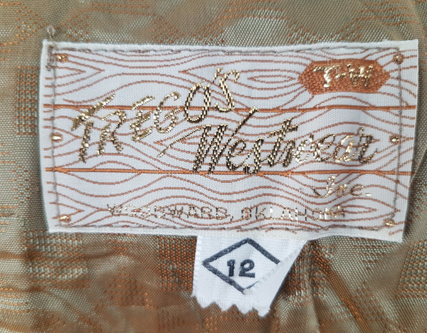 Label of vintage 1960s Trego’s Westwear chenille coat with a fully buttoned funnel collar, colourful geometric stripes and angled pockets 