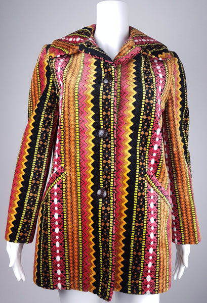 Full front view of a vintage 1960s Trego’s Westwear chenille coat with an unbuttoned funnel collar, colourful geometric stripes and angled pockets displayed on a mannequin 