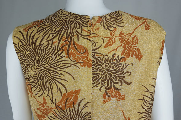 Close-up back view of the Vintage 1970s Alfred Shaheen Gold Metallic Floral Maxi Dress showing the upper floral print, shoulder seams and centre-back construction.