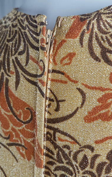 Close-up of the metal rear zipper and hook-and-eye neckline closure on a vintage 1970s Alfred Shaheen maxi dress.