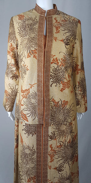 Front view of the vintage gold floral jacket fastened over the matching maxi dress in the vintage 1970s Alfred Shaheen Gold Metallic Floral Maxi Dress & Jacket Set 