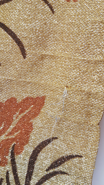Condition close-up showing a minor loose thread in the metallic knit near the lower rear of the dress.