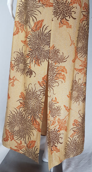 Alternate lower back view of the gold metallic maxi dress showing its centre-back slit and full lining.