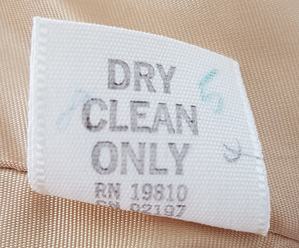 Close-up of the vintage care label marked Dry Clean Only and RN 19810.