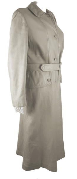 three-quarter view of a vintage 1970s sand-coloured leather trench coat with tonal buttons, shoulder tabs and a matching belt displayed on a mannequin