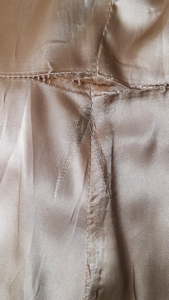 Inner lining view of a vintage 1970s sand-coloured leather trench coat 