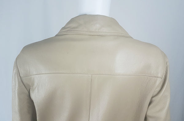 Back shoulder and collar view of a vintage 1970s sand-coloured leather trench coat with tonal buttons, shoulder tabs and a matching belt displayed on a mannequin