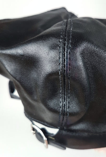 Rear view showing the adjustable buckle strap and purple ink marks along the crown seam