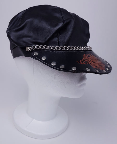 Three quarter view of Black biker cap styled on a mannequin with a Harley-Davidson emblem, studded peak and silver-tone chain