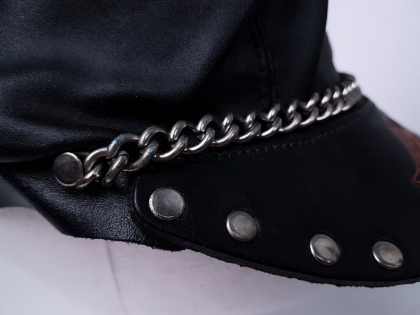 Side close-up showing the studded peak and silver-tone chain extending around the cap