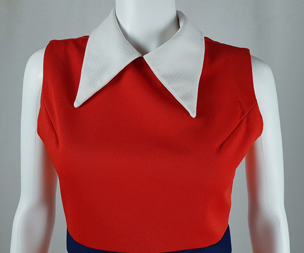 Close-up front view of a vintage 1970s Kenny Classics Donnkenny orange-red mod dress with a contrasting white pointed collar displayed on a mannequin