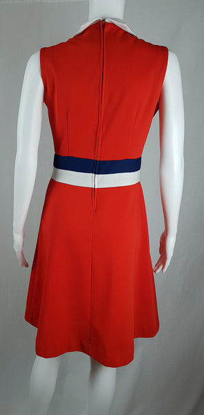 Full Back view of a vintage 1970s Kenny Classics Donnkenny orange-red mod dress with a white collar, navy and white waist bands displayed on a mannequin