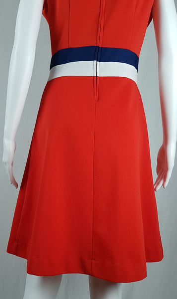 Back view of a vintage 1970s Kenny Classics Donnkenny orange-red mod dress with contrasting navy and white waist bands displayed on a mannequin