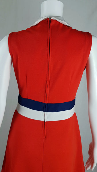 Close up back view of a vintage 1970s Kenny Classics Donnkenny orange-red mod dress with a white collar, navy and white waist bands displayed on a mannequin