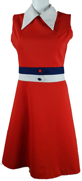 Full front view of a vintage 1970s Kenny Classics Donnkenny orange-red mod dress with a white pointed collar, navy and white waist bands and contrasting covered buttons displayed on a mannequin