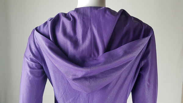 Back Hood and shoulder view of a 1970s Nu-Mode purple jumpsuit with a draped hood, V-neckline, front zip and ties, long sleeves and wide legs displayed on a mannequin 