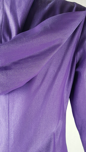 Back Hood view of a 1970s Nu-Mode purple jumpsuit with a draped hood, V-neckline, front zip and ties, long sleeves and wide legs displayed on a mannequin 