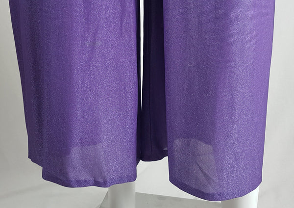 Legs and hem view of a 1970s Nu-Mode purple jumpsuit with a draped hood, V-neckline, front zip and ties, long sleeves and wide legs displayed on a mannequin 