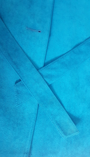 Close-up of the matching turquoise tie belt showing a faint localized mark