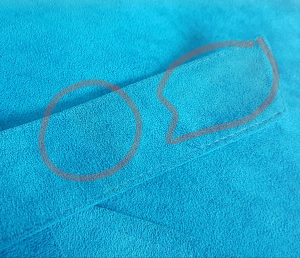 Detailed condition photograph identifying faint marks on the turquoise faux-suede belt