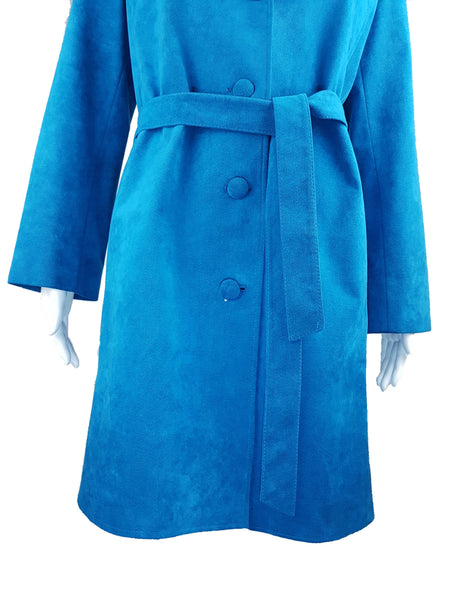 Front view of the knee-length turquoise coat buttoned and tied at the waist