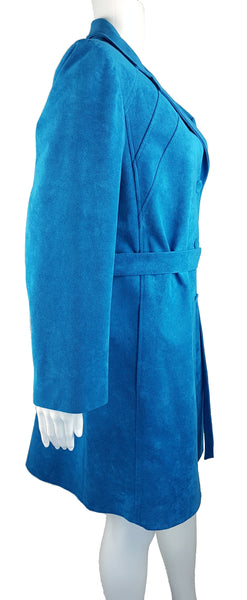 Three quarter view of a vintage 1970s turquoise faux-suede coat with oversized lapels, buttons and matching tie belt