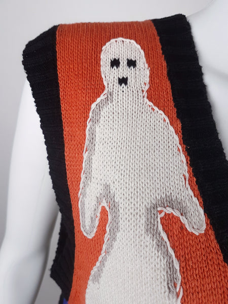 Close-up of the white intarsia-knit ghost against the orange Halloween panel