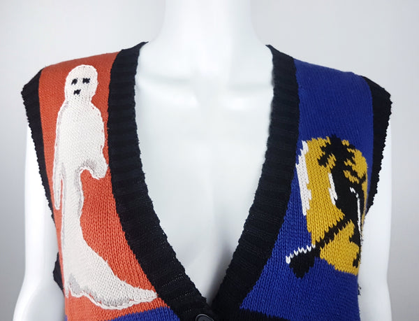 Close-up of the ribbed black V-neckline and upper ghost and witch motifs
