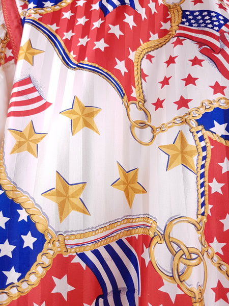 Close-up of the bold USA flag, star and gold-chain print on a vintage 1980s - 1990s Mureli silk bomber jacket.